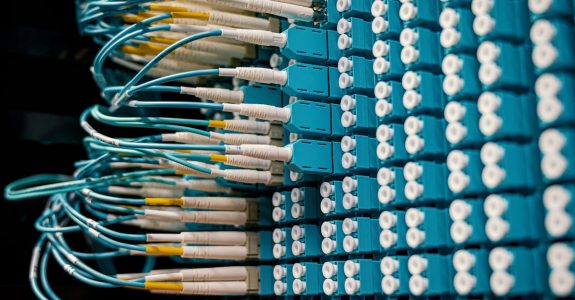 close-up-of-a-network-patch-panel-with-connected-blue-fiber-optic-cables-1